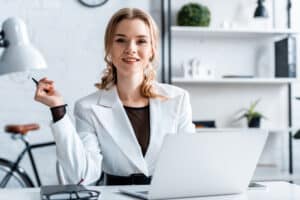 smiling business woman in formal wear in the office