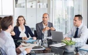 business meeting people around a glass table at a meeting