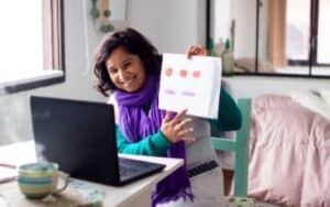 woman with purple scarf teaching online