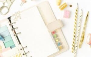 cream planner with gold paper clips and pens best planners for bloggers